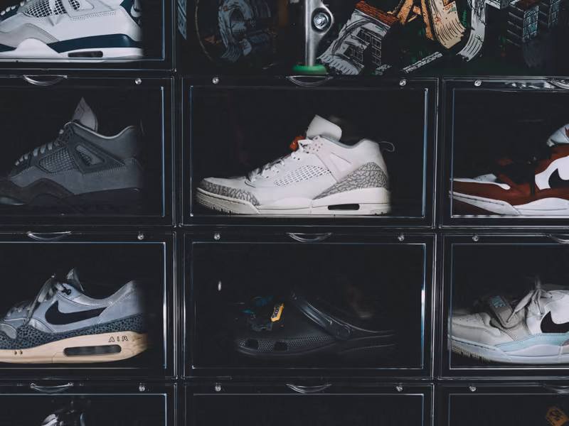 Trainers displayed in clear stacking boxes.