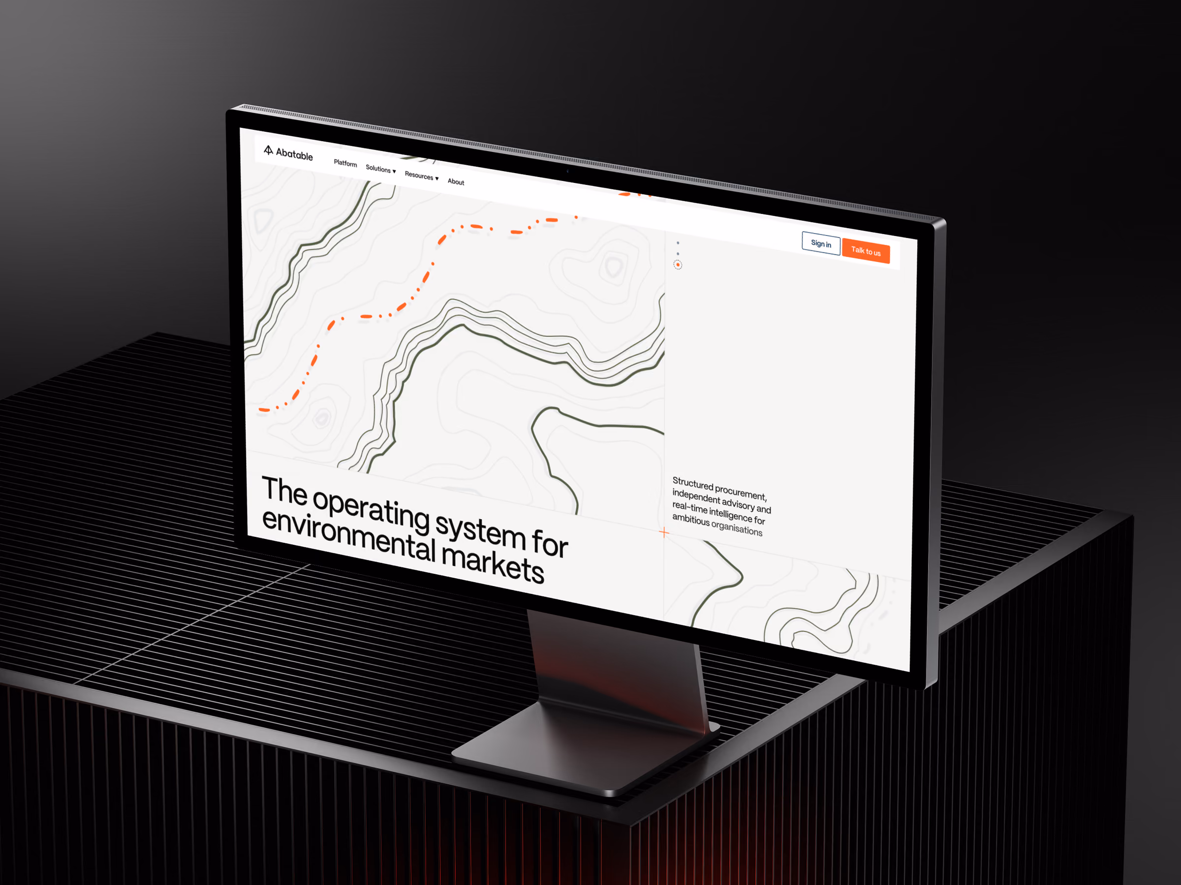 The new Abatable homepage on a desktop monitor: topographic contour lines behind the headline “The operating system for environmental markets”